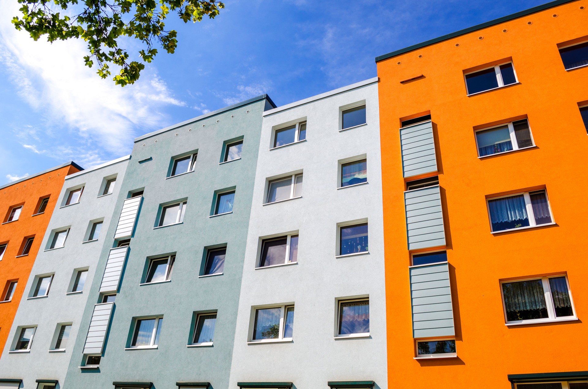 Colorful house facades with windows of apartment buildings