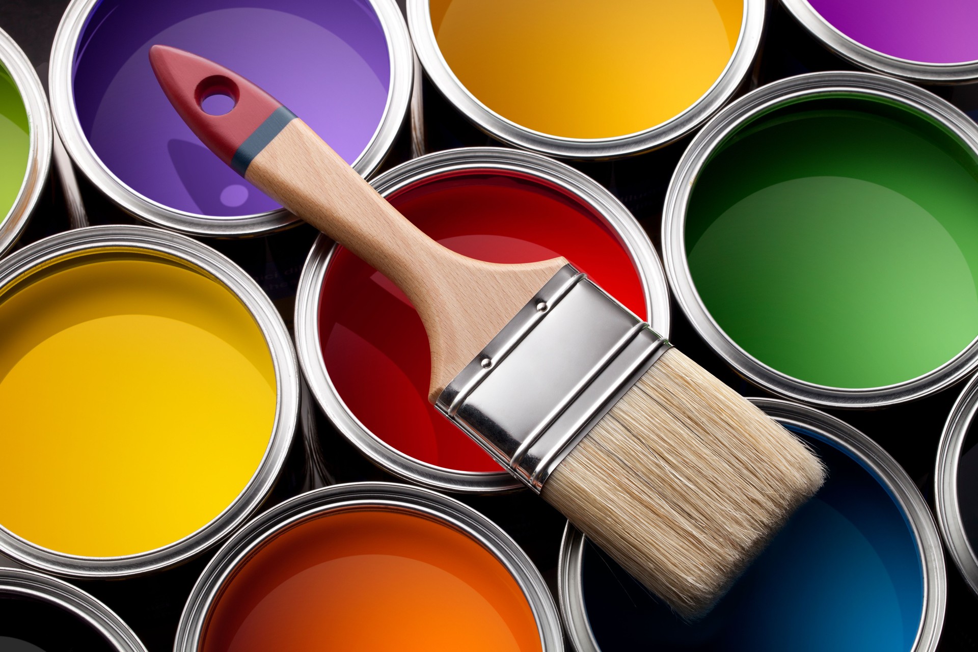 Colorful paint cans with brush